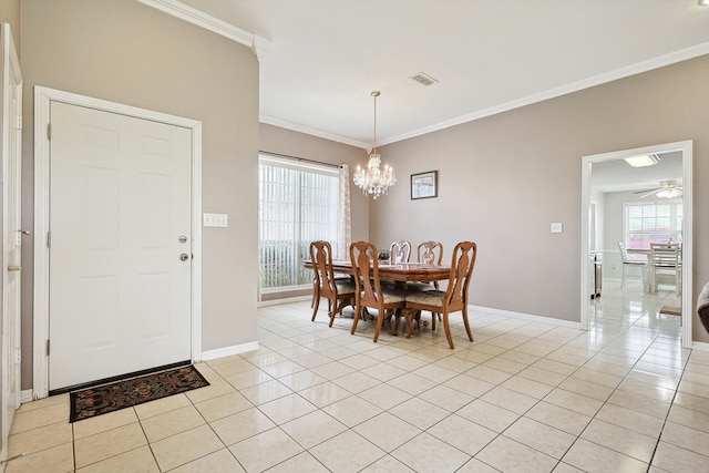 tiled dining space with ceiling fan with notable chandelier and ornamental molding