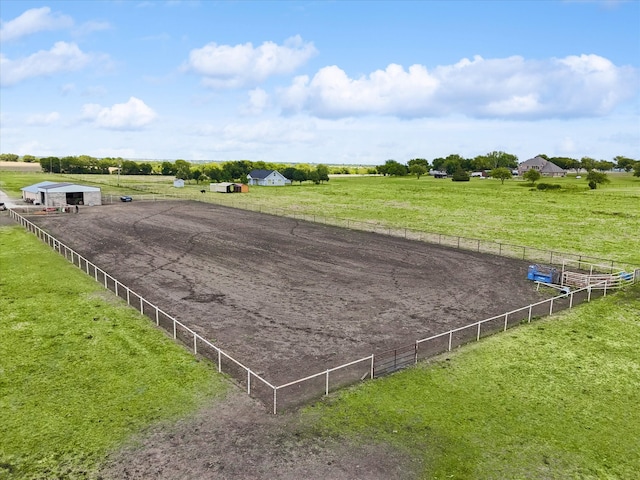 view of horse barn with a rural view and a lawn