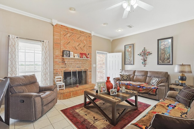 living room with light tile patterned floors, a brick fireplace, brick wall, ceiling fan, and ornamental molding