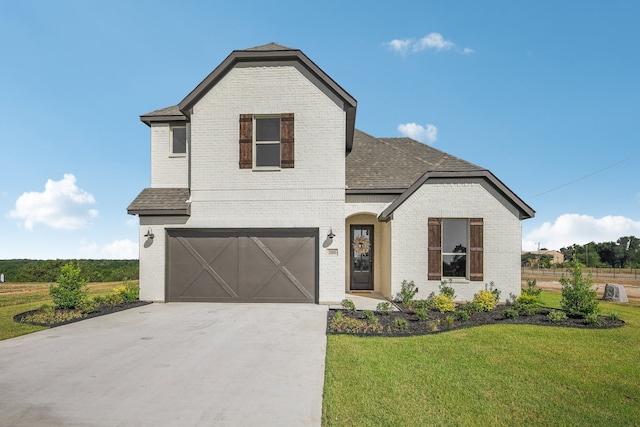 view of property featuring a garage and a front yard