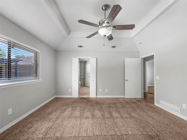 unfurnished bedroom featuring crown molding, ceiling fan, carpet flooring, and a raised ceiling