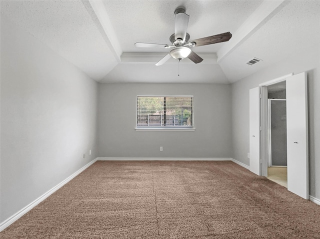 unfurnished bedroom with ceiling fan, a raised ceiling, carpet, and a textured ceiling