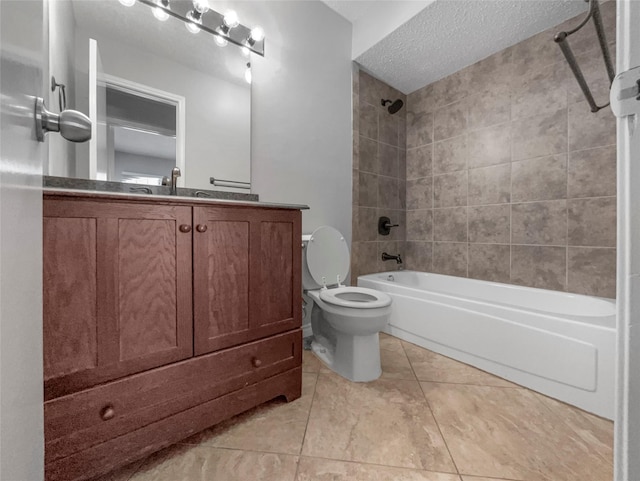 full bathroom with toilet, a textured ceiling, vanity, tiled shower / bath combo, and tile patterned flooring