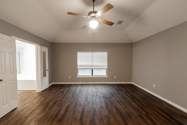 spare room featuring vaulted ceiling, hardwood / wood-style floors, and ceiling fan