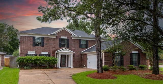 colonial inspired home featuring a garage