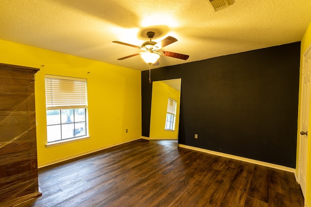 empty room featuring ceiling fan, a textured ceiling, and hardwood / wood-style flooring