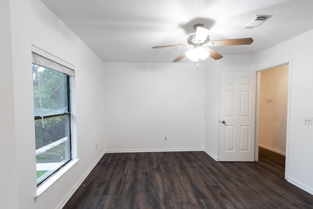 empty room featuring ceiling fan, hardwood / wood-style flooring, and a healthy amount of sunlight