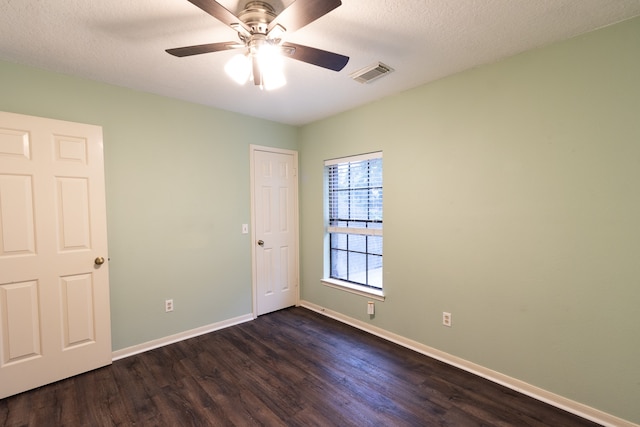 spare room with hardwood / wood-style flooring, a textured ceiling, and ceiling fan