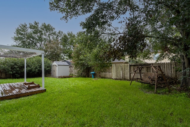 view of yard featuring a storage shed, a wooden deck, and a pergola