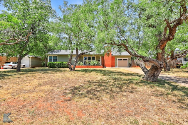 ranch-style house with a front lawn and a garage