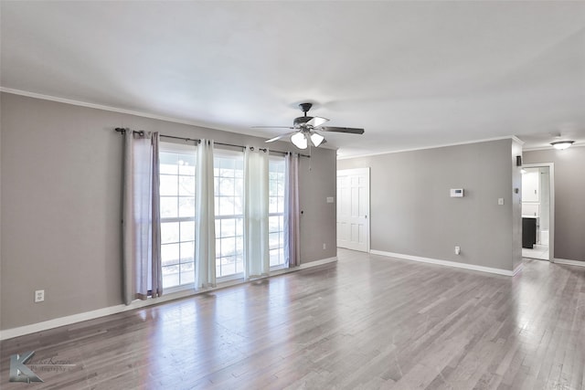 empty room with ceiling fan, hardwood / wood-style floors, and crown molding