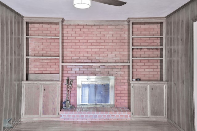 interior details with crown molding, wood walls, and hardwood / wood-style flooring