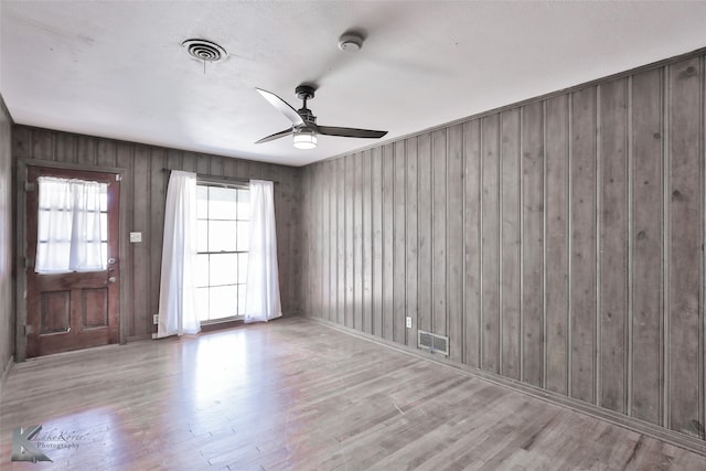 unfurnished room with ceiling fan and light hardwood / wood-style flooring