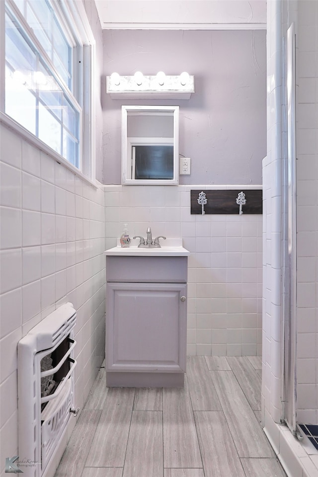 bathroom with tile walls and vanity