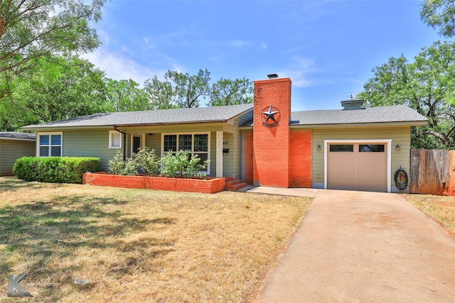 ranch-style home with a garage and a front lawn