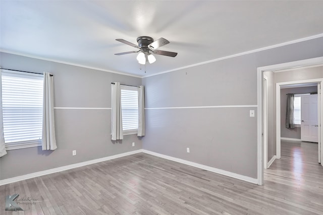 spare room featuring ceiling fan, ornamental molding, and light hardwood / wood-style flooring