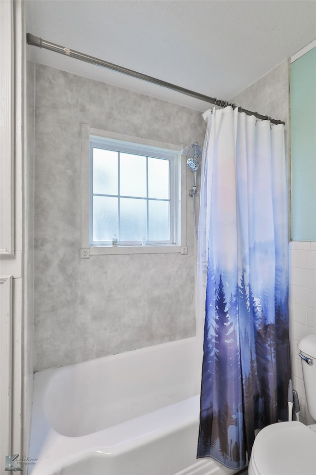 bathroom with shower / bath combo with shower curtain and toilet