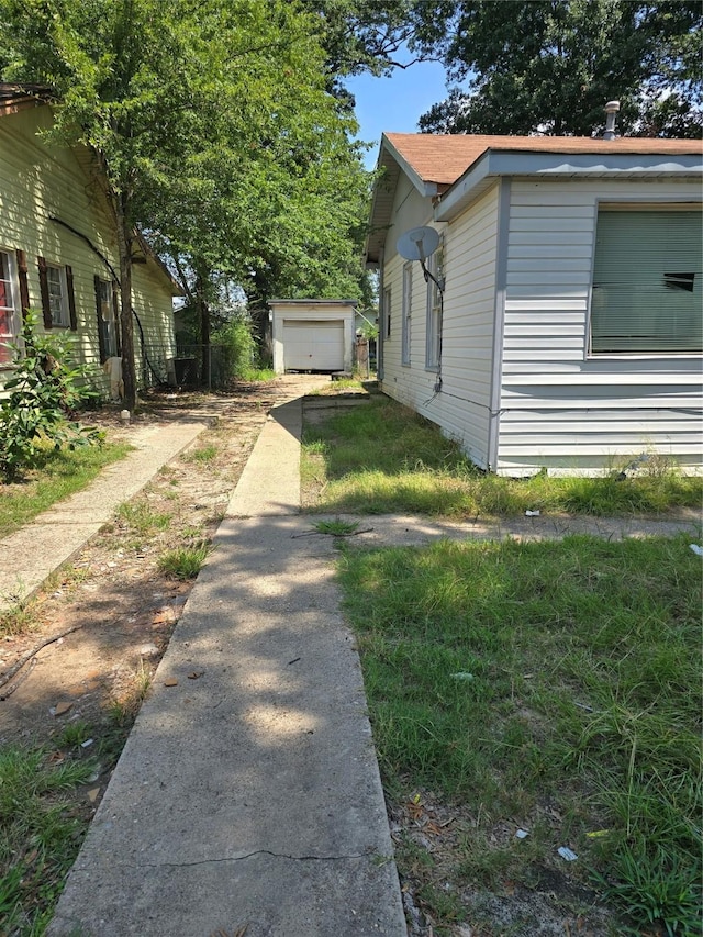 view of side of property with a garage and an outdoor structure