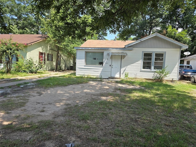 rear view of property with a yard