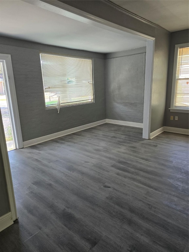 spare room with dark wood-type flooring