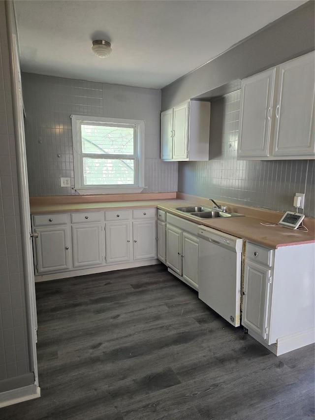 kitchen with dishwasher, sink, and white cabinets