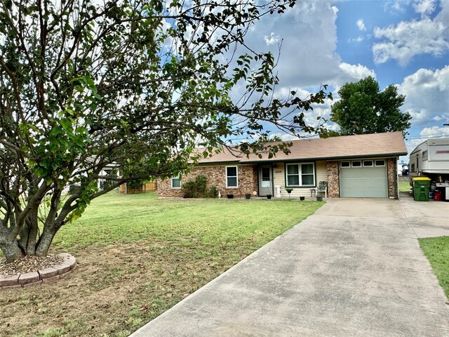 ranch-style home with a garage and a front lawn