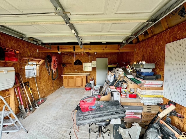 garage featuring wood walls and a workshop area