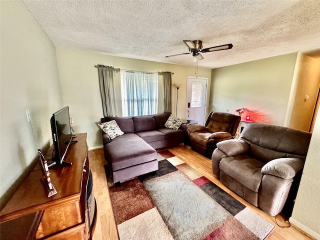 4506 Azalea Dr, Granbury, TX 76049 - living area featuring wood finished floors, a textured ceiling, a ceiling fan, and baseboards