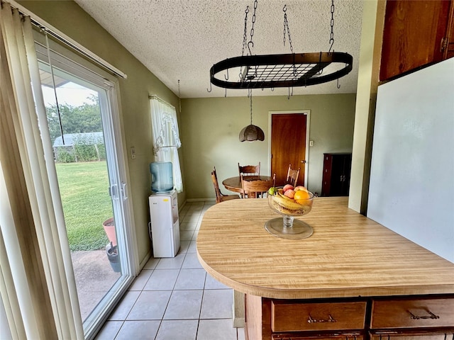 4506 Azalea Dr, Granbury, TX 76049 - dining room featuring light tile patterned flooring and a textured ceiling