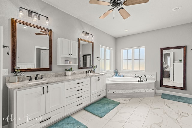 bathroom with double vanity, ceiling fan, tile patterned flooring, and a relaxing tiled tub