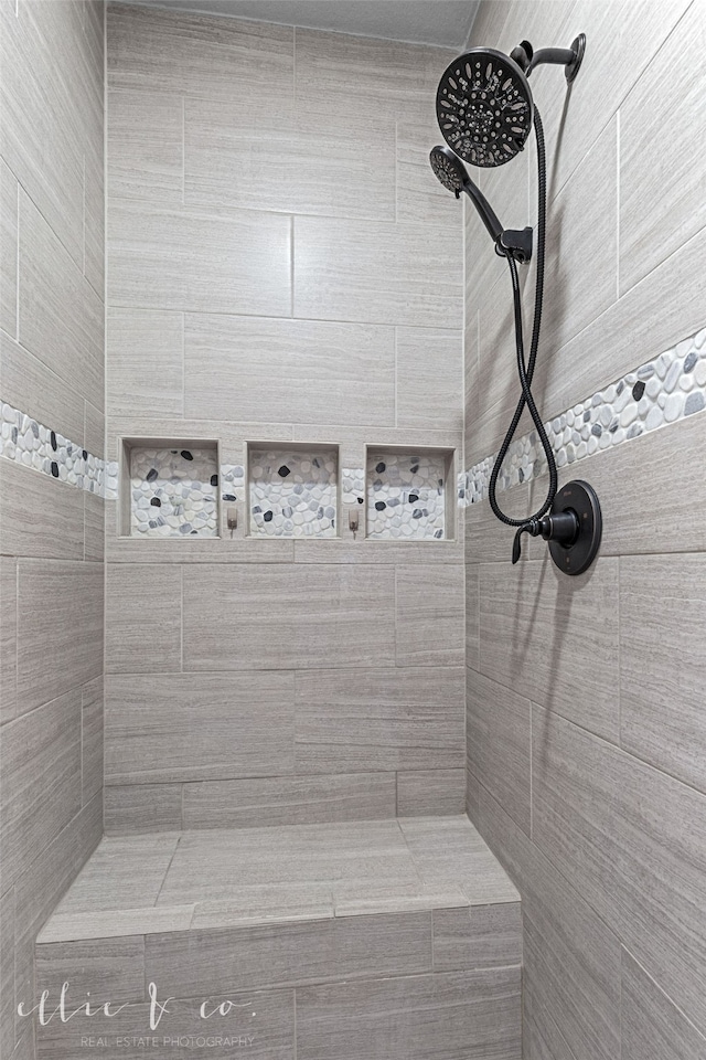 bathroom with tiled shower