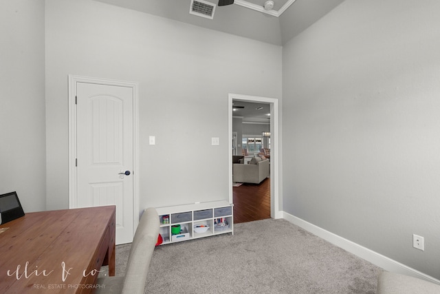 office area featuring carpet and a towering ceiling