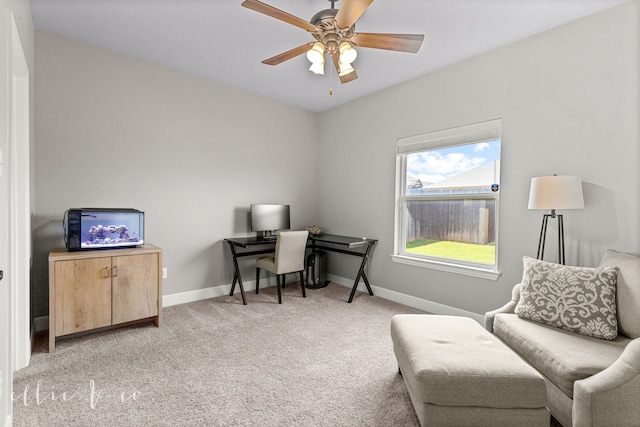 carpeted office space with ceiling fan