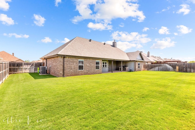 rear view of property featuring a patio, cooling unit, and a lawn