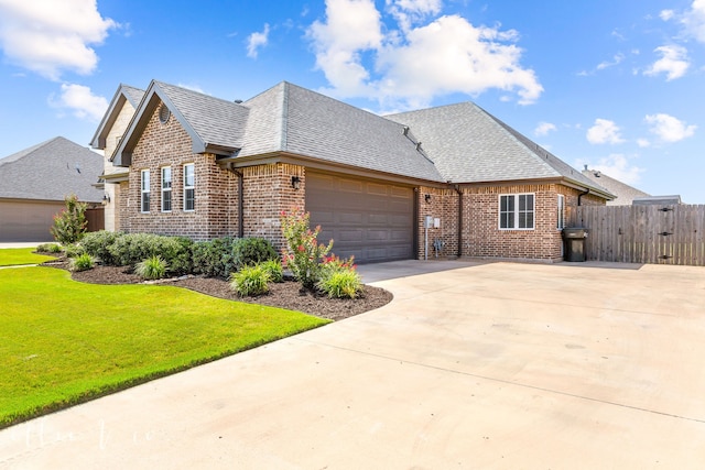 view of front of house featuring a garage and a front yard