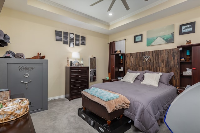 bedroom with light carpet, ceiling fan, a raised ceiling, and ornamental molding