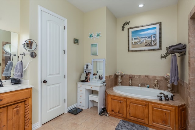 bathroom featuring tile patterned floors, vanity, and a bath