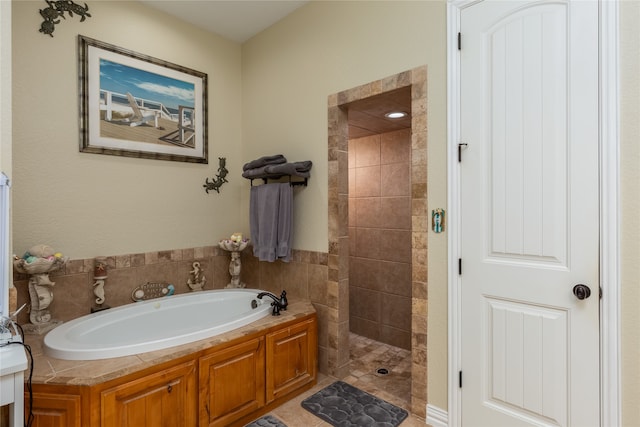 bathroom featuring shower with separate bathtub