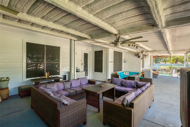 view of patio with an outdoor living space and ceiling fan