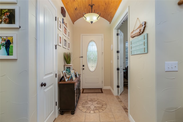 interior space with wooden ceiling, lofted ceiling, and light tile patterned floors