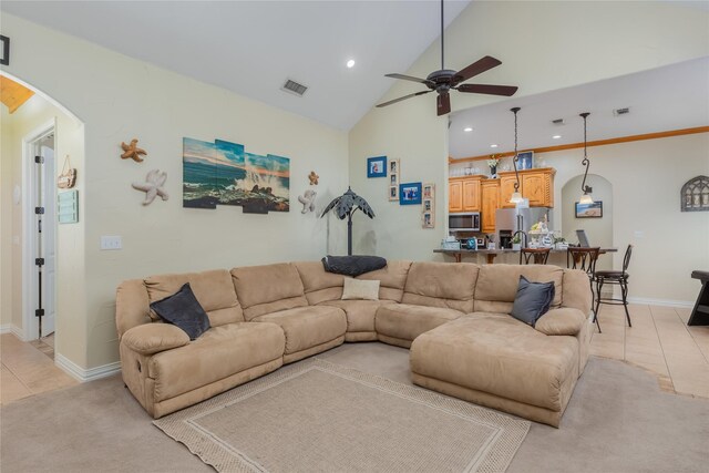 tiled living room with high vaulted ceiling and ceiling fan