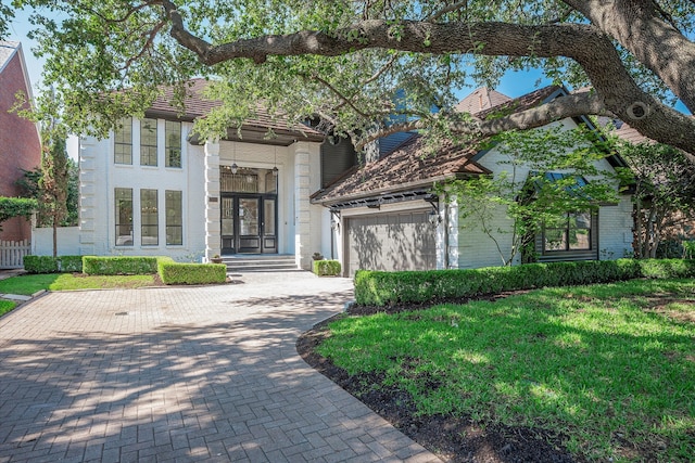 view of front facade with a garage and a front lawn