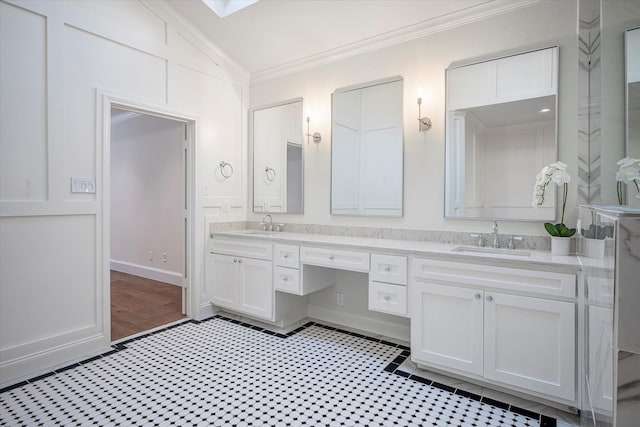 bathroom featuring wood-type flooring, vaulted ceiling, crown molding, and double sink vanity