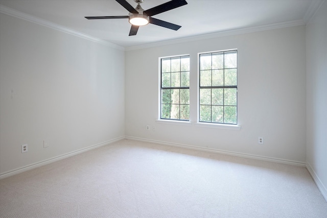 carpeted empty room with crown molding and ceiling fan