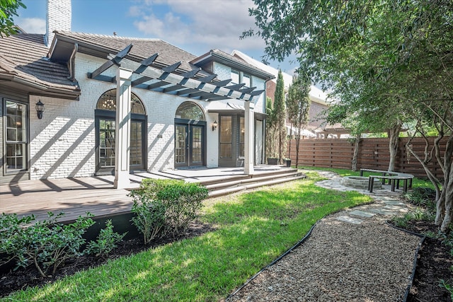 back of property with a deck and a pergola