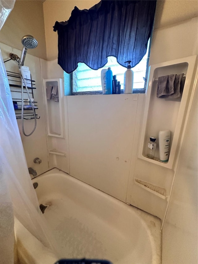 bathroom featuring shower / bath combo with shower curtain