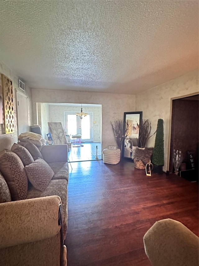 living room featuring dark hardwood / wood-style flooring and a textured ceiling