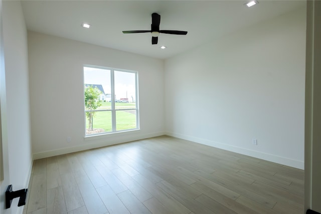 unfurnished room with ceiling fan and light wood-type flooring