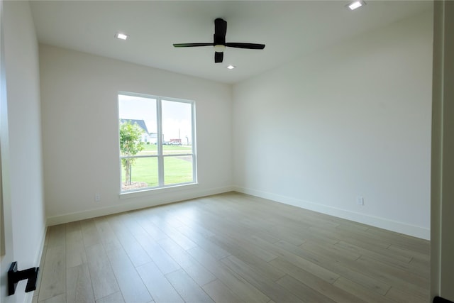 empty room with light hardwood / wood-style floors and ceiling fan