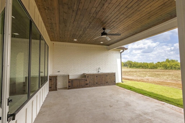 view of patio / terrace with ceiling fan and sink